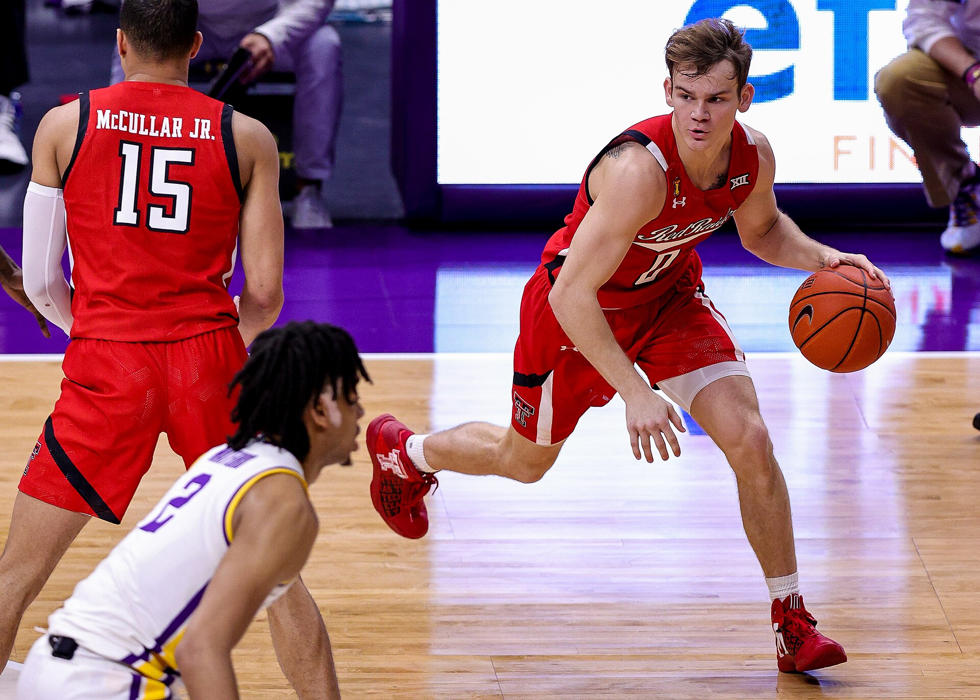 Jan 30, 2021; Baton Rouge, Louisiana, USA; Texas Tech Red Raiders guard Mac McClung (0) dribbles against LSU Tigers forward Trendon Watford (2) during the first half at Pete Maravi